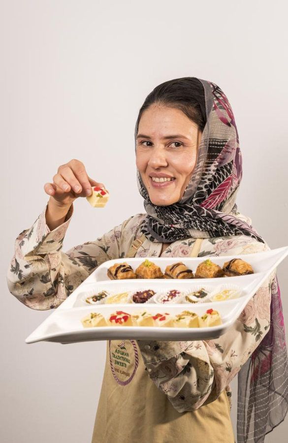 Sita Nabizada holding a tray of sweets